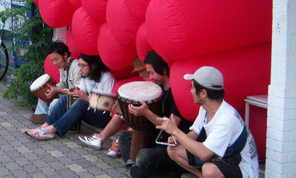 Drummers by Stuffed Full Drummers play sitting near an inflatable installation by Jimmy Kuehnle