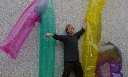 Inflatable 76 James Kuehnle holds up two inflatable numbers for Gallery 76