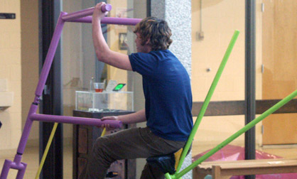 Fuck Bike Wenatchee Valley College student pedaling out of the gallery on a bike