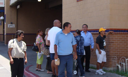 Spectotors in Laredo, Texas Pedestrians look on as Jimmy Kuehnle bounds down the street in an inflatable suit