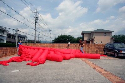 Jimmy Kuehnle and Kjell Hahn test inflating a large inflatable installation before shipping it to America from Japan