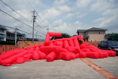 Jimmy Kuehnle and Kjell Hahn test inflating a large inflatable installation before shipping it to America from Japan
