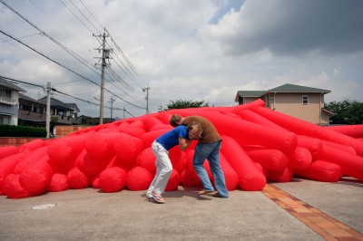 Jimmy Kuehnle and Kjell Hahn test inflating a large inflatable installation before shipping it to America from Japan