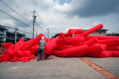 Jimmy Kuehnle and Kjell Hahn test inflating a large inflatable installation before shipping it to America from Japan