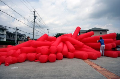 Jimmy Kuehnle and Kjell Hahn test inflating a large inflatable installation before shipping it to America from Japan
