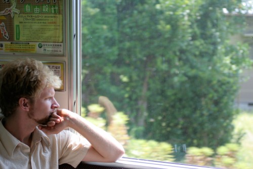 Jimmy Kuehnle looks out the window of a train in Japan
